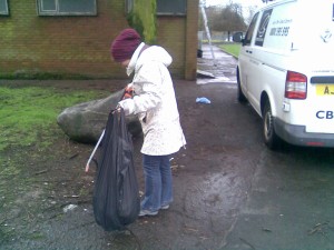 Volunteer collecting litter in car park
